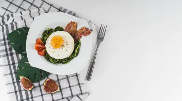Bacon and egg on spinach bed