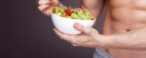 man holding a bowl of salad closeup body shot