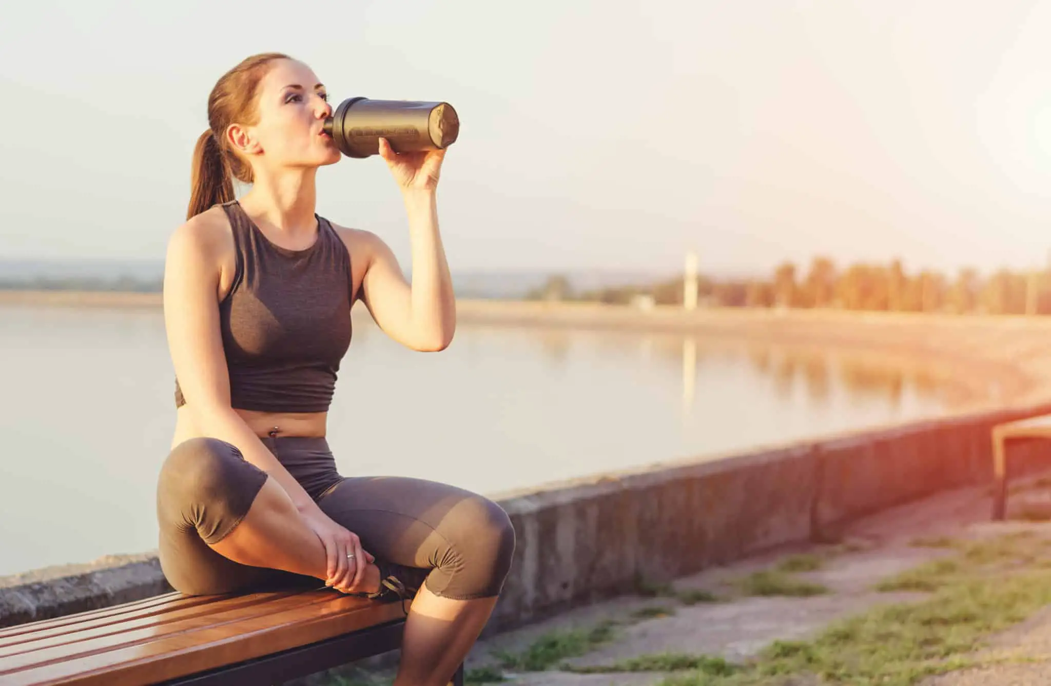 fit woman drinking from a bottle